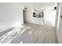 Open concept living area with light wood flooring, kitchen view, and lots of natural light at 5222 Mandalay Springs Dr # 202, Las Vegas, NV 89120