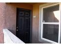 Unit 2005 features a dark front door with a window to the right at 555 E Silverado Ranch Blvd # 2005, Las Vegas, NV 89183