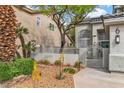 Inviting front yard with mature trees, wrought iron gate, and desert landscaping at 6 Desert Dawn Ln, Henderson, NV 89074