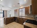 Well-equipped kitchen with granite countertops, stainless steel appliances, and ample cabinet space at 6237 Glimmering Light Ave, Las Vegas, NV 89139