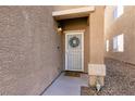 Inviting front entrance with decorative wreath and a charming welcome mat at 7936 Dexter Falls St, Las Vegas, NV 89149