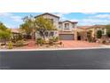 Charming two-story home with a brick driveway, stone accents, and a well-maintained front yard at 872 Timber Walk Dr, Henderson, NV 89052
