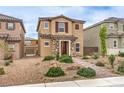 View of a two-story home with stone accents, desert landscaping, and tiled roof at 1115 Brilliant Meadow Ave, North Las Vegas, NV 89086
