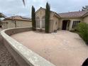 Spacious front courtyard with lush landscaping and a charming entrance to the single-story home at 1654 Danbury Crossing Dr, Henderson, NV 89052