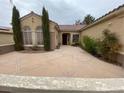 Inviting front entrance with well-maintained landscaping and a spacious courtyard area for outdoor enjoyment at 1654 Danbury Crossing Dr, Henderson, NV 89052