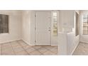 Bright entryway with tile flooring, a security door, and natural light from the window at 178 Beach Oak Ave, Henderson, NV 89002