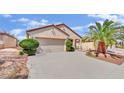 Single-story home with a spacious driveway and well-maintained landscaping at 2077 Wildwood Lake St, Henderson, NV 89052