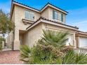 Attractive two-story home featuring stucco siding, tile roof, and green window shutters at 2106 Polynesia Cir, Henderson, NV 89074