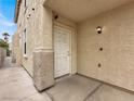 Welcoming front entrance with a classic white door and traditional exterior lighting at 2106 Polynesia Cir, Henderson, NV 89074