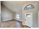 Inviting entryway showcases vaulted ceilings, a large window, and durable wood-look flooring at 2428 Greens Ave, Henderson, NV 89014