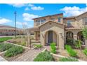 Inviting home facade featuring a covered entrance, manicured landscaping, and a well-maintained walkway at 2449 Padulle Pl, Henderson, NV 89044