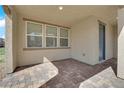 A covered patio with brick flooring offers a cozy outdoor living space at 2449 Padulle Pl, Henderson, NV 89044