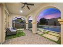 Covered patio with brick flooring, outdoor seating, fan, and views of the pool and backyard at 2804 Candelaria Dr, Henderson, NV 89074