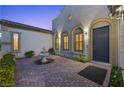 Charming front yard with decorative fountain and brick-paved entrance to the house at 2804 Candelaria Dr, Henderson, NV 89074
