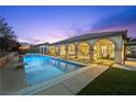 Backyard oasis with a sparkling pool, spa, covered patio, and manicured landscaping at 2804 Candelaria Dr, Henderson, NV 89074