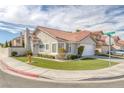 Attractive single-story home with a two-car garage, tile roof and artificial front lawn at 301 Montcliff Ave, Henderson, NV 89074