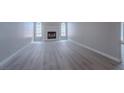 Bright living room with a fireplace, neutral paint, and sleek gray flooring at 325 Greenfield Ln, Las Vegas, NV 89107