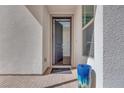 Open front door with welcome mat, blue planter, and modern exterior architecture at 3264 Monte Luna Ave, Henderson, NV 89044