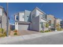 Modern two-story home with gray and white color scheme, landscaped front yard, and attached two-car garage at 3264 Monte Luna Ave, Henderson, NV 89044