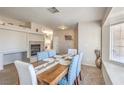 Bright dining room with a fireplace, a large window, and a wooden dining table at 3700 Hedge Grove Dr, North Las Vegas, NV 89032