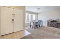 Inviting dining room featuring a bay window, carpet floors, and a modern table set at 3700 Hedge Grove Dr, North Las Vegas, NV 89032