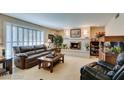 Inviting living room with a cozy fireplace, comfortable seating, and bright window at 3727 Centennial Cir, Las Vegas, NV 89121