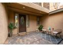 Cozy front porch featuring pavers, sitting area with stylish furniture, and decorative plants at 3829 Hawkeye Falls Ave, North Las Vegas, NV 89085