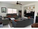 Bright living room featuring neutral paint, a ceiling fan and tiled floors at 3844 Hollycroft Dr, North Las Vegas, NV 89081