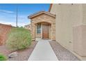 Charming front entrance with stone accents, desert landscaping and a secure front door at 4224 Galapagos Ave, North Las Vegas, NV 89084