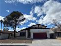 Charming single Gathering home with a two car garage, mature tree, and beautiful blue sky at 4417 De Forest St, Las Vegas, NV 89103