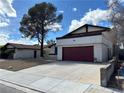 Charming single Gathering home with a two car garage, mature tree, and beautiful blue sky at 4417 De Forest St, Las Vegas, NV 89103