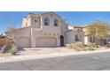 Charming stucco home featuring a three-car garage, landscaped yard, and a welcoming facade at 505 Punto Vallata Dr, Henderson, NV 89011