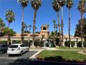 A clubhouse surrounded by towering palm trees and parking space at 5220 Mission Carmel Ln # 103, Las Vegas, NV 89107