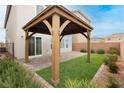 Backyard featuring a gazebo on a brick patio next to a patch of artifical grass at 5384 Knitmore Ct, Las Vegas, NV 89139