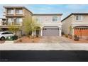 Charming two-story home featuring an attached two-car garage and a beautifully landscaped front yard at 5384 Knitmore Ct, Las Vegas, NV 89139