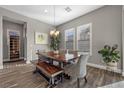 Traditional dining room features wood floors, chandelier and wine fridge at 5523 Taylor Rose Ave, Las Vegas, NV 89139