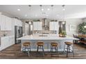 Kitchen with white cabinets, large island, stainless appliances and wood floors at 5523 Taylor Rose Ave, Las Vegas, NV 89139