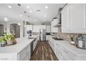 Bright eat-in kitchen featuring stainless appliances, a large island and tile backsplash at 5523 Taylor Rose Ave, Las Vegas, NV 89139