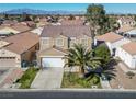 An aerial view of a desert home with a red tile roof and desert landscaping at 5854 Heather Marie Dr, Las Vegas, NV 89110