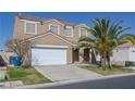Two-story home featuring a two-car garage, drought resistant landscaping, and desert charm at 5854 Heather Marie Dr, Las Vegas, NV 89110