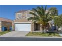 Inviting two-story home featuring a well-kept front yard and a convenient two-car garage with ample parking at 5854 Heather Marie Dr, Las Vegas, NV 89110