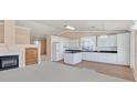 Bright kitchen featuring white cabinetry, granite countertops, and center island providing extra counter space at 6151 Naha Port Ave, Las Vegas, NV 89110