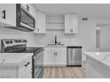 Modern kitchen features stainless steel appliances, white cabinets, and sleek marble countertops at 617 Stanford St, Las Vegas, NV 89107