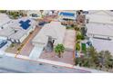 Aerial shot of a single-Gathering home with a neutral palette, surrounded by desert landscaping and neighboring residences at 6440 N Bruce St, North Las Vegas, NV 89086