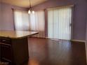 Light-filled dining area with modern lighting and a sliding glass door at 7008 Copperleaf Dr, Las Vegas, NV 89128
