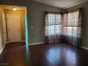 Open-concept living area with natural light and beautiful wood-look flooring at 7008 Copperleaf Dr, Las Vegas, NV 89128