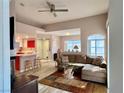 Comfortable living space showcasing a vaulted ceiling, ceiling fan, and seamless access to the kitchen at 7400 W Flamingo Rd # 2058, Las Vegas, NV 89147