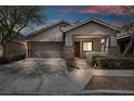 Beautiful one-story home features a two-car garage, landscaped front yard and cozy front porch at 7877 Saber Tooth St, Las Vegas, NV 89149