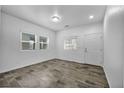 Bright room with wood-look tile flooring, fresh white paint and plenty of natural light at 7877 Saber Tooth St, Las Vegas, NV 89149