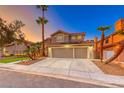 Two-story home features a spacious three-car garage, desert landscaping, and mature trees at 8240 Campana Dr, Las Vegas, NV 89147